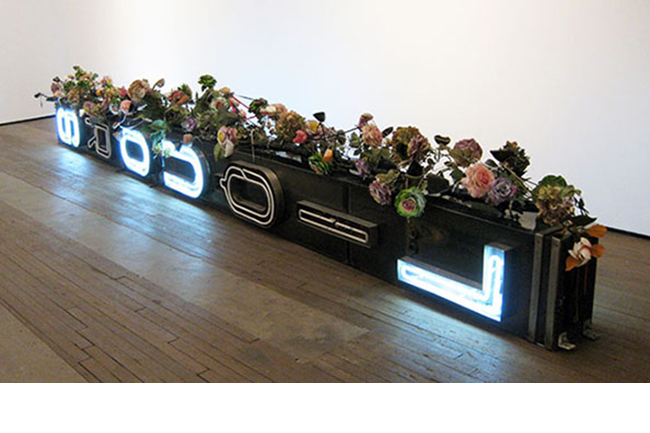 Nari Ward, <i>Xquisite LiquorsouL,</i> 2009. Metal, neon, wood with artificial flowers, shoelaces and shoe tips; 34 x 250 x 32 in. Courtesy the artist and Lehmann Maupin, New York and Hong Kong. Nari Ward
