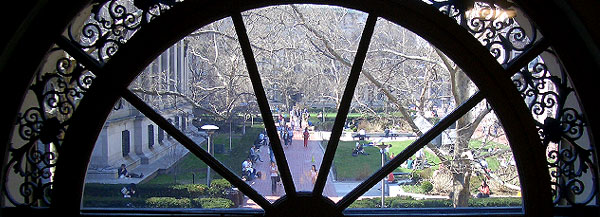 A view of campus through an arched window in Avery Hall.