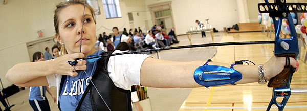 Sara Goshorn CC '10, the leading scorer for the 2006-7 Columbia archery team, lines up a shot at the Friends and Family Shoot in Barnard's newly renovated LeFrak Gymnasium.