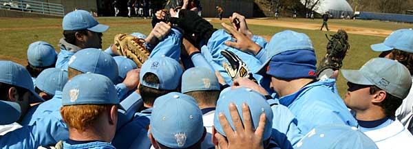 The Columbia Lions baseball team in a huddle before a game.