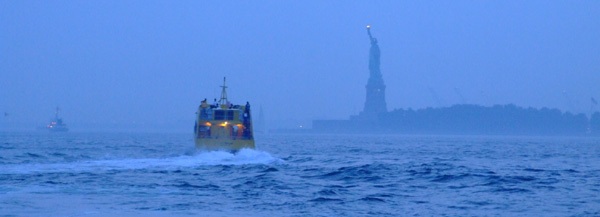 A ferry boat approaches the Statue of Liberty.