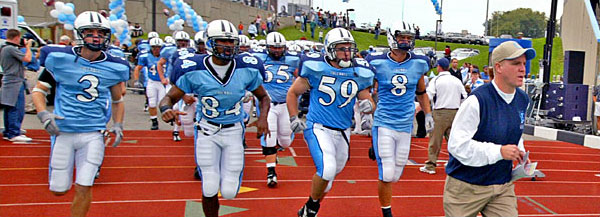 Head Coach Bob Shoop leads the Columbia Lions football team onto the field.