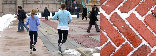 Braving the elements, Columbia University students jog across Low Plaza.