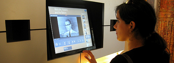 A student explores a multimedia kiosk built by Columbia University for the Malcolm X and Dr. Betty Shabazz Memorial and Educational Center.