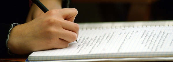 A student takes notes during a class.