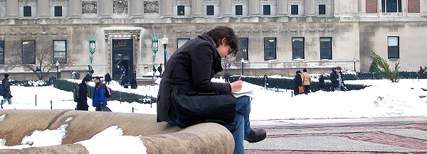 A student pauses to work on the rim of a fountain in Low Plaza.