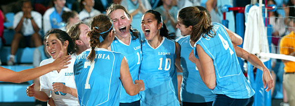 The Columbia Lions volleyball team celebrates after a victory.