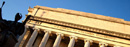 A low-angle view of Low Library and the statue of Alma Mater.