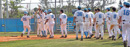 The Columbia Lions baseball team comes out to congratulate a team member scoring the winning run.