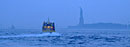 A ferry boat approaches the Statue of Liberty.