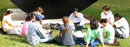 A class meets outside Uris Hall on a spring day.