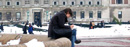 A student pauses to work on the rim of a fountain in Low Plaza.