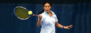 A member of the Columbia Lions women's tennis team returns the ball.